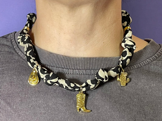 Collar artesanal con dije dorado y pañuelo trenzado, diseño bohemio hecho a mano por Hilma.