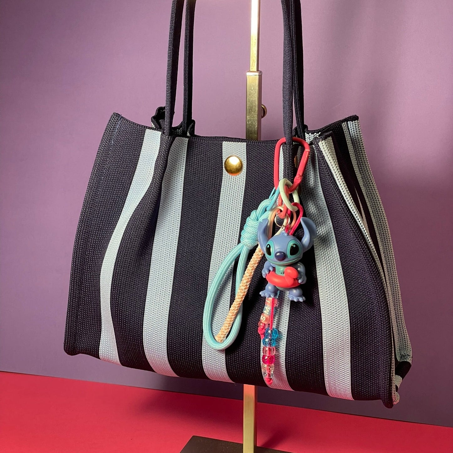 Llavero artesanal colorido con colgantes decorativos y cordones.