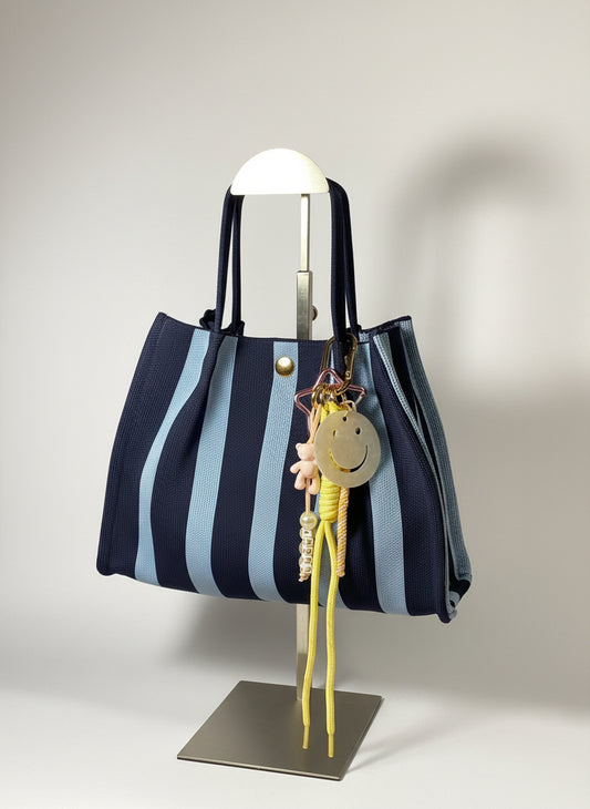 Llavero artesanal colorido con colgantes decorativos y cordones.