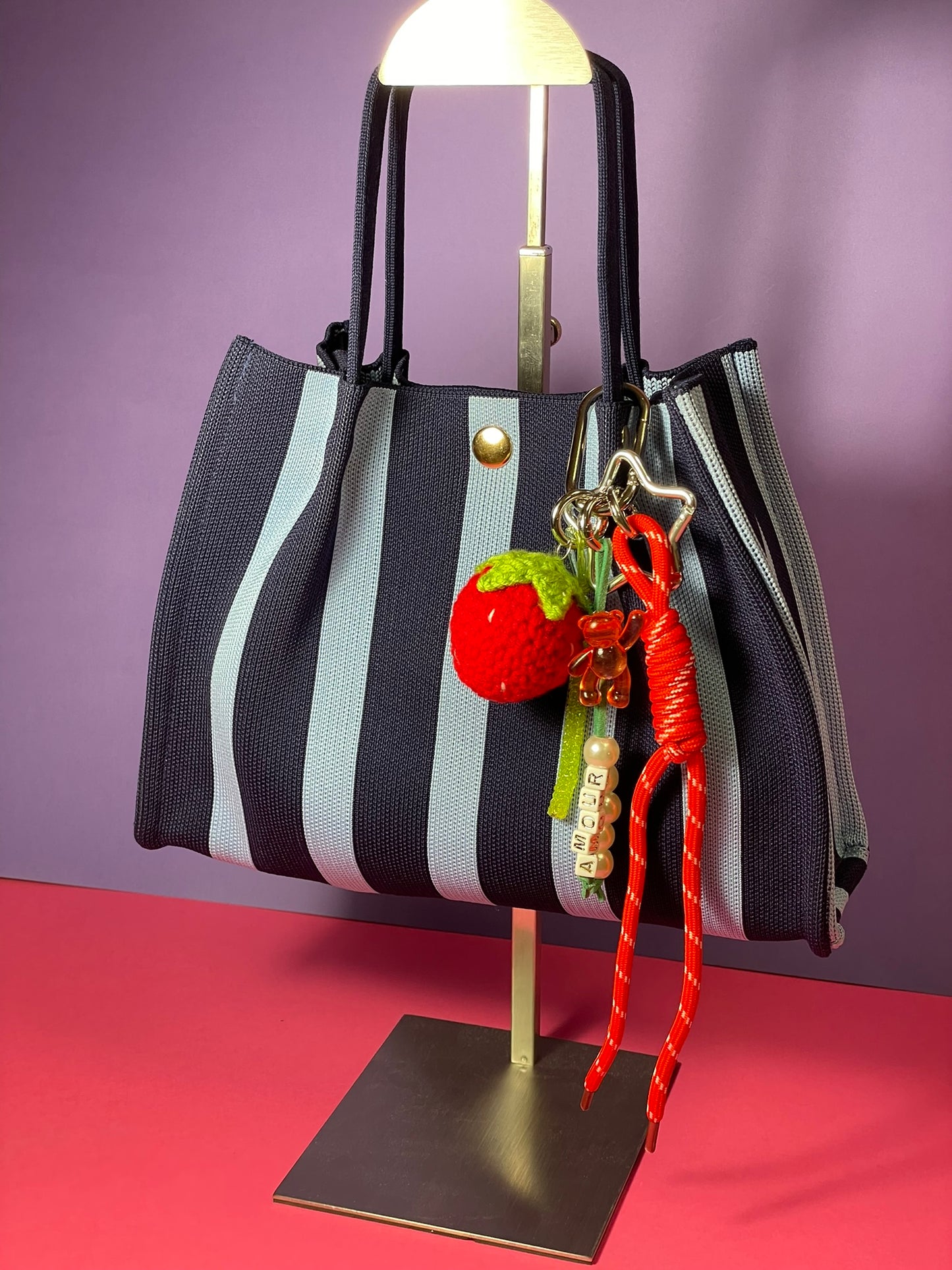 Llavero artesanal colorido con colgantes decorativos y cordones.