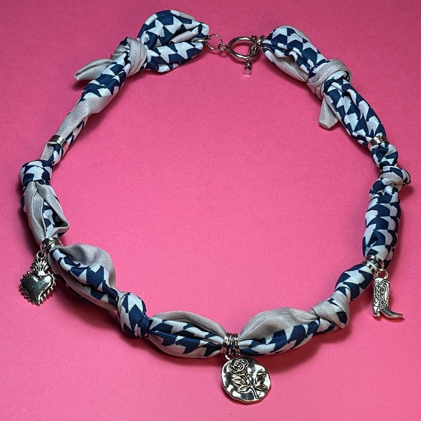 Collar artesanal con dije dorado y pañuelo trenzado, diseño bohemio hecho a mano por Hilma.