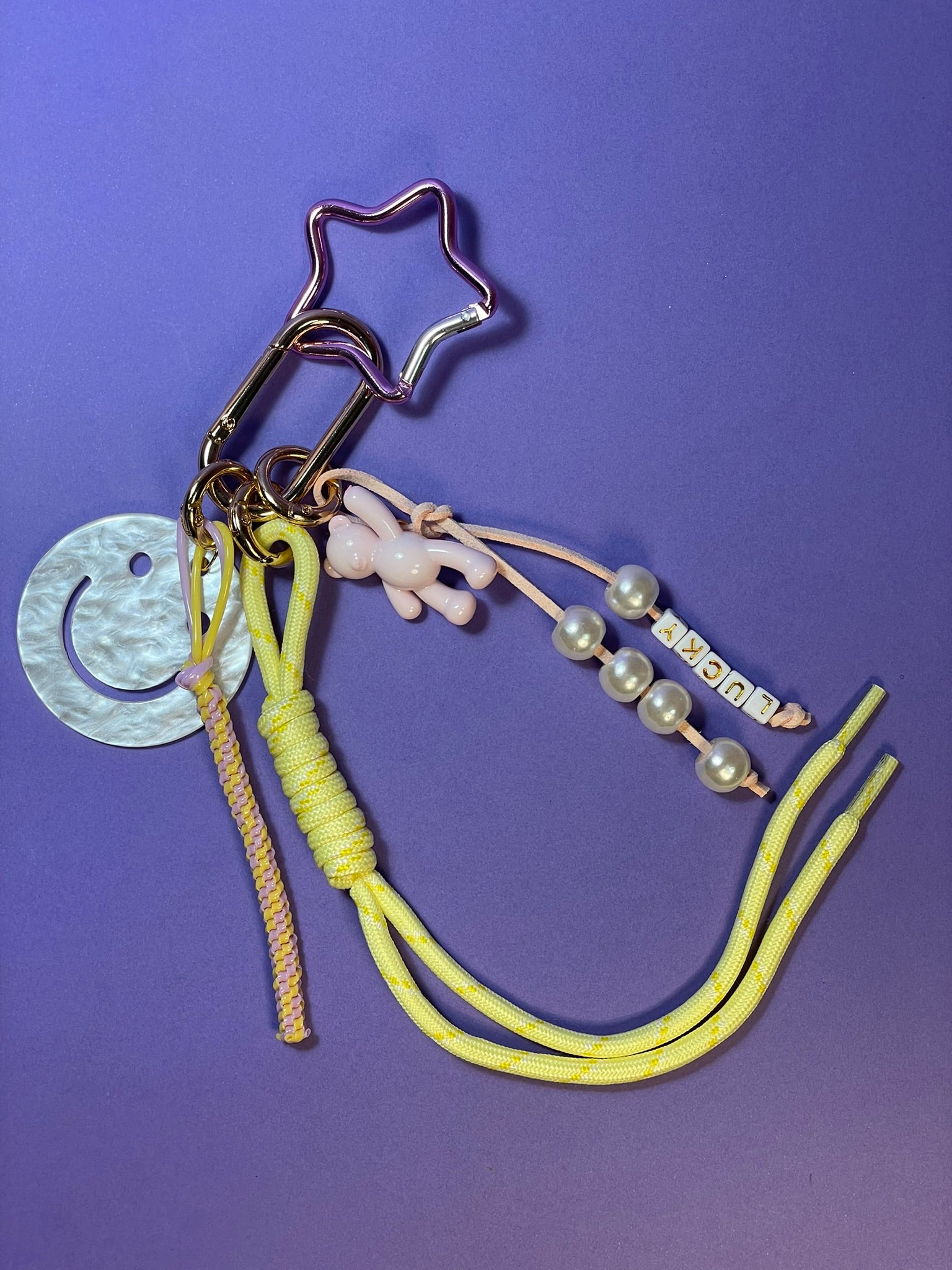 Llavero artesanal colorido con colgantes decorativos y cordones.