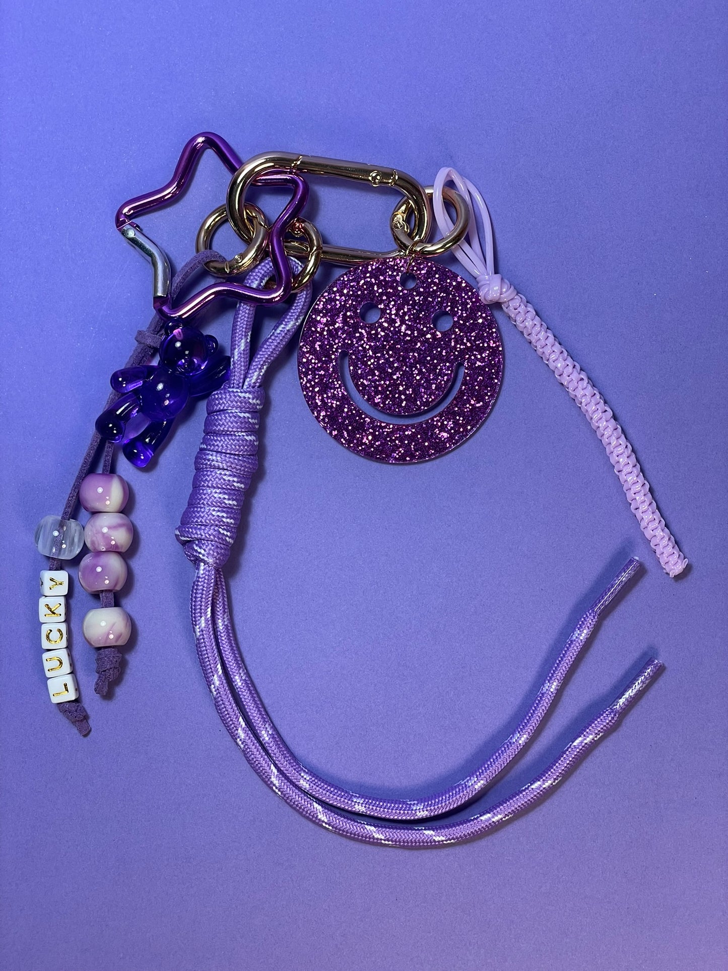 Llavero artesanal colorido con colgantes decorativos y cordones.