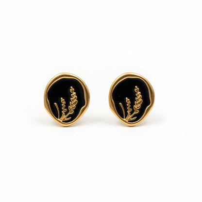 Pendientes dorados de acero inoxidable en forma circular negra con dibujo Hilma Studio